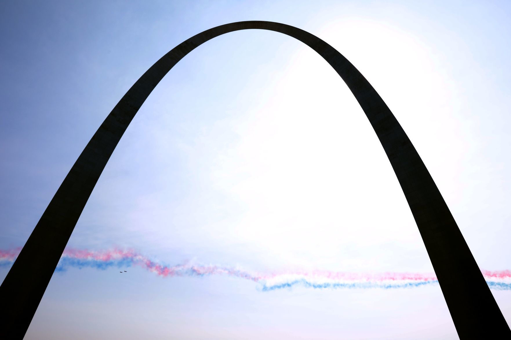 UK's Royal Air Force Red Arrows fly over the Arch